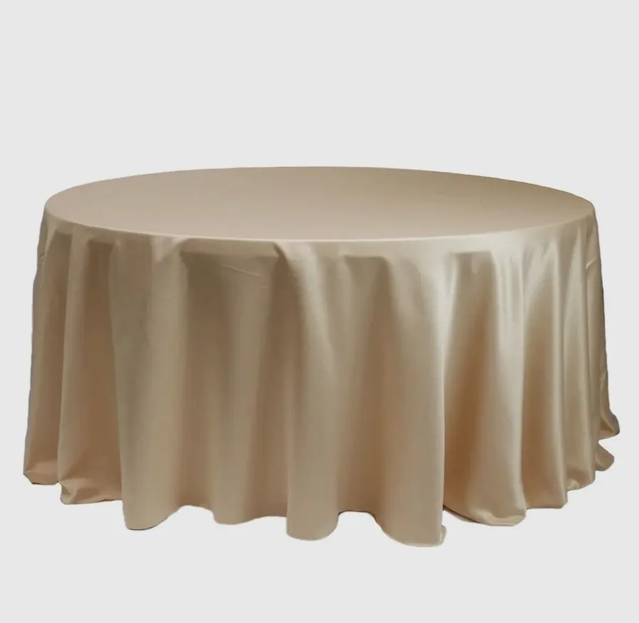 A round table dressed in a champagne table cloth